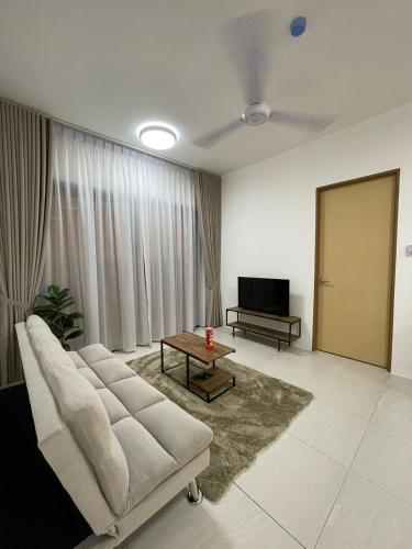 a living room with a couch and a table at 7-06 Kenny Hill Residence 1 Kuching in Gua Sai
