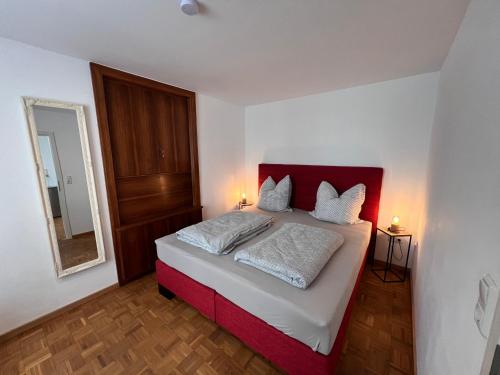 a bedroom with a bed with two pillows on it at Ferienwohnung Scheuring EG in Nordheim