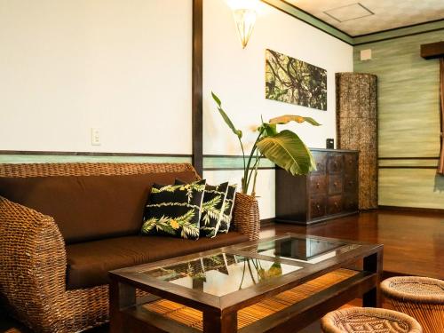 a living room with a couch and a coffee table at Haruhoo Resort ISHIGAKI in Ishigaki Island