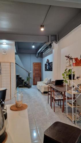 a living room with a couch and a table at Casita Hostel House Bangkok in Bangkok