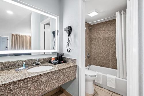 a bathroom with a sink and a toilet at Suburban Studios Harvey - New Orleans in Harvey