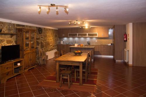 a kitchen with a wooden table in a room at Casa da Fecha in Parada