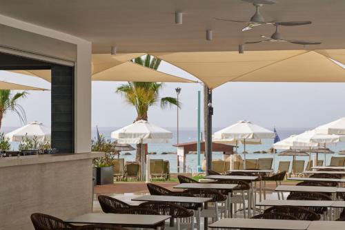 a row of tables and umbrellas at a restaurant at Atlantica Callisto in Ayia Napa