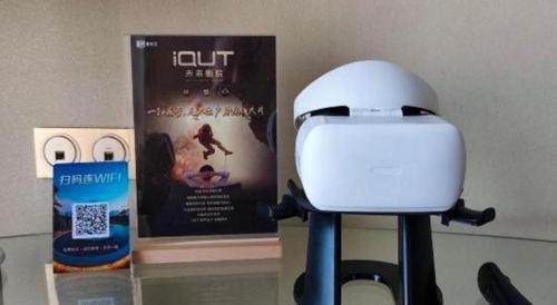 a video camera next to a movie and a book at King Century Hotel in Zhongshan