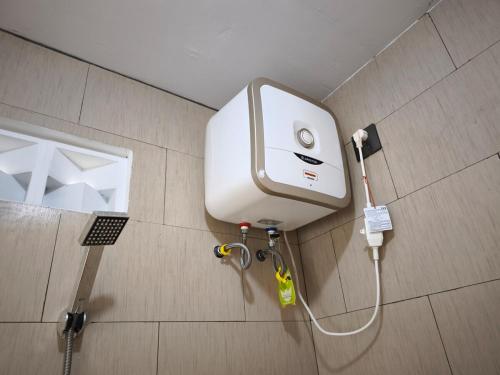 a water tank on the wall of a bathroom at Villa Royal Arois Unit C-01 in Batu