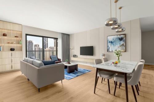 a living room with a table and a dining room at Marriott Executive Apartments Kuala Lumpur in Kuala Lumpur
