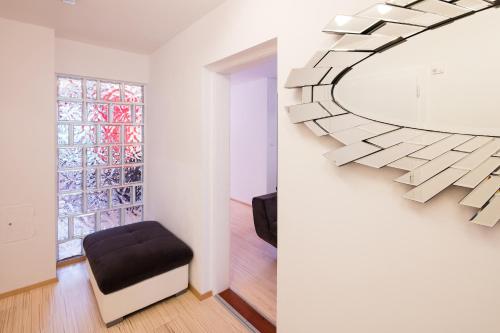 a living room with a mirror and a chair at W & S Executive Apartments - Hallstatt I in Hallstatt