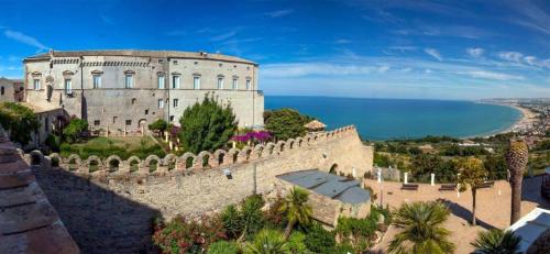 a castle on a hill next to the ocean at Corte Santa Maria B&B in Vasto