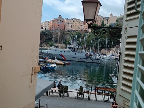 a boat is docked in a harbor with a city at Nid douillet - maison Spinola in Bastia