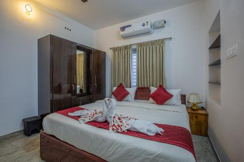 a bedroom with two beds with towels on them at Sree Bharat Apartment in Coimbatore