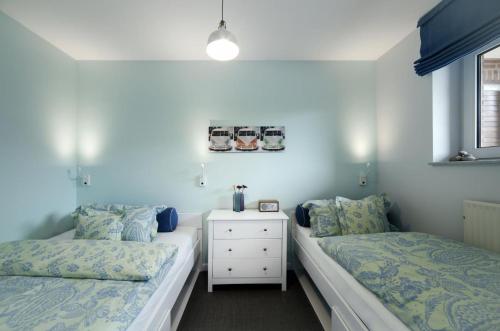 En eller flere senge i et værelse på Meerblick Lemkenhafen – Ferienwohnung