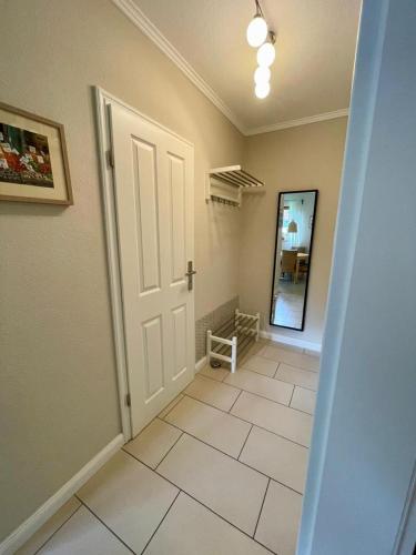 a hallway with a door and a tiled floor at Lüttes Glück in Lemkenhafen in Lemkenhafen auf Fehmarn