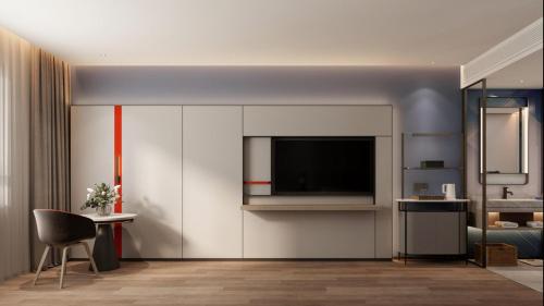 a living room with a tv on a wall at Holiday Inn Express Harbin Central Avenue by IHG in Harbin