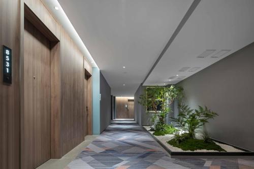 a hallway with plants on the walls of a building at Holiday Inn Express Harbin Central Avenue by IHG in Harbin