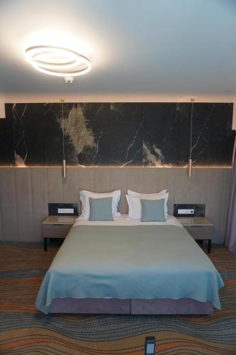 Ένα ή περισσότερα κρεβάτια σε δωμάτιο στο Hotel Romanita