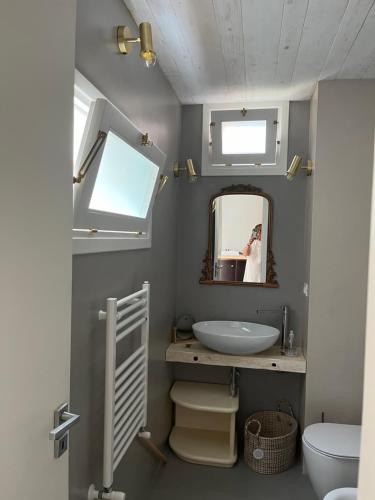 a bathroom with a sink and a mirror and a toilet at A CASA DEL CONSOLE in Mondello