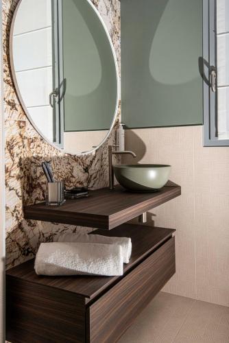 a bathroom with a sink and a mirror at Hotel Europa Lignano in Lignano Sabbiadoro