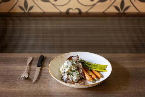 a plate of food with meat and vegetables on a table at Four Points by Sheraton Halifax in Halifax