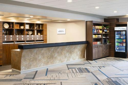 a lobby of a pharmacy with a counter and shelves at Four Points by Sheraton Halifax in Halifax