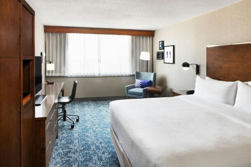 a hotel room with a bed and a desk and a chair at Four Points by Sheraton Halifax in Halifax