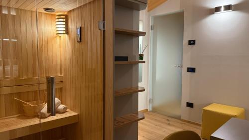 a room with a hallway with wooden walls and a room with a desk at A&F LUXURY Rooms Pinzolo in Pinzolo