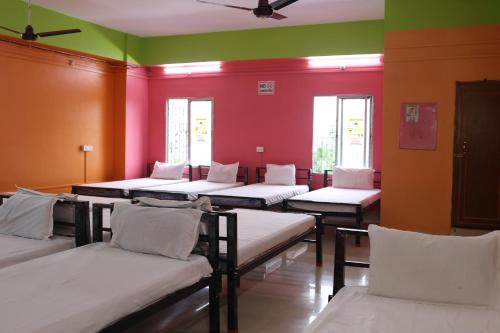 a room with a bunch of beds in it at Sacred Stay in Guwahati