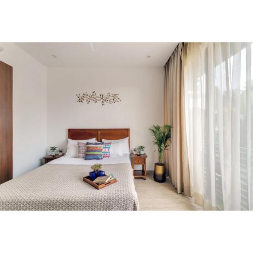 a bedroom with a bed and a window at Dia Hotels and Homes Nerul Goa - Villas and Apartments in Nerul