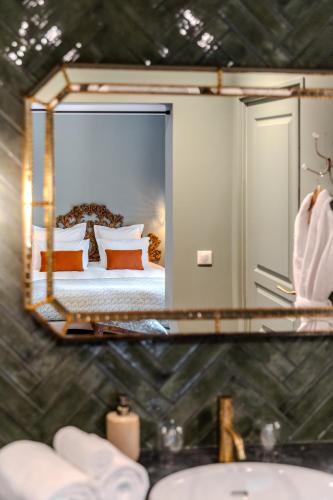 a mirror over a sink in a bedroom with a bed at Chateau Pascalette in La Londe-les-Maures