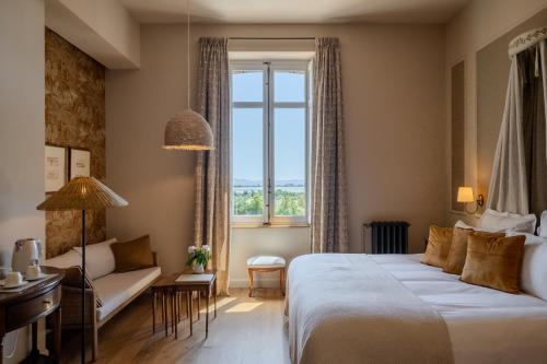 a hotel room with a bed and a window at Chateau Pascalette in La Londe-les-Maures