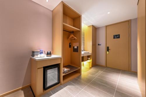 a room with a fireplace and a bathroom at Atour Hotel Dalian Hi-tech Zone in Dalian