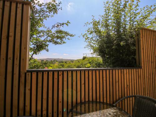 a view from a deck with a fence and a window at Stiper View Barn 1 in Shrewsbury
