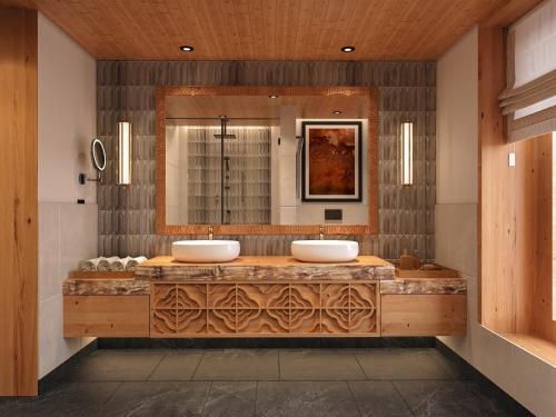 a bathroom with two sinks and a large mirror at Taj Gangtey Resort and Spa Bhutan in Tshalunang