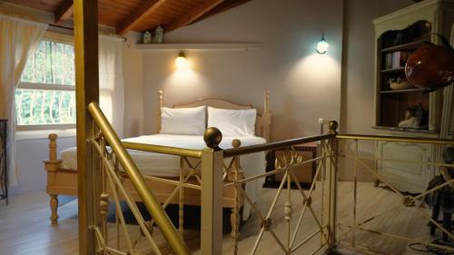 a bedroom with a bed with white sheets and a window at ART HOUSE in Parga
