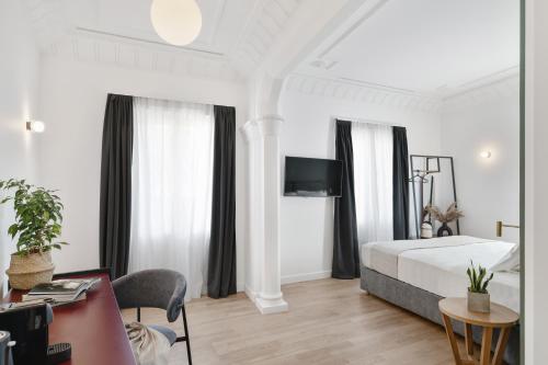 a hotel room with a bed and a desk at Morus Acropolis Boutique Hotel in Athens