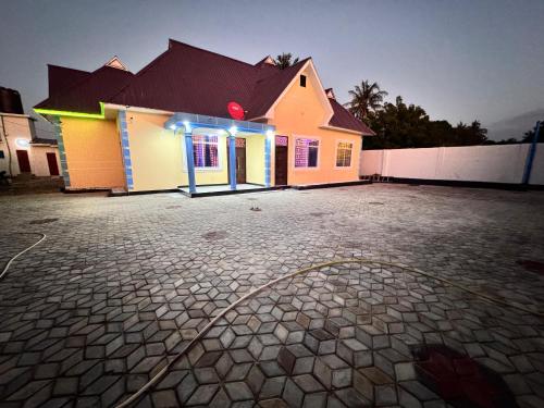a house with a light on the side of it at Eden Crest Lodge in Dar es Salaam