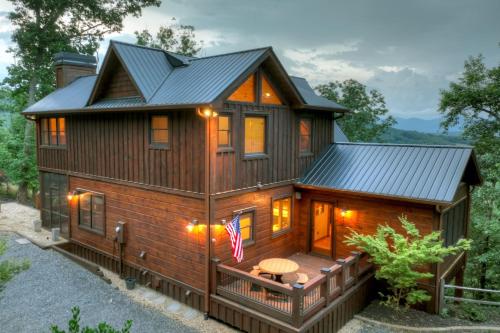 a log cabin with a deck and a house at Honey Hill Gorgeous long-range mountain views in Morganton