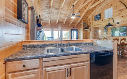 a kitchen with a sink and a stove at Lifes a Bear in Gatlinburg