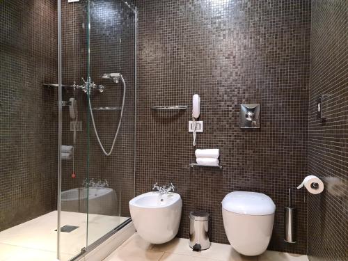 a bathroom with a shower and a toilet and a sink at Palazzo Ai Capitani in Peschiera del Garda