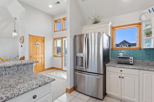 a kitchen with a stainless steel refrigerator at 5115 - Salt Therapy in Kill Devil Hills