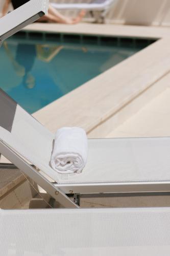 a hospital bed with a towel on it next to a swimming pool at Maison Sirolo in Sirolo