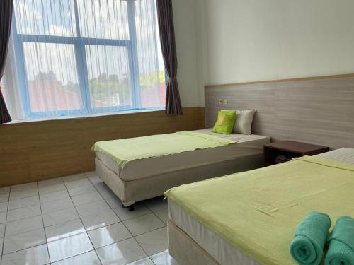 Postel nebo postele na pokoji v ubytování Hotel Huswah Airport