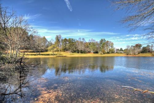 a large body of water with trees in the background at Moon Tower Cabin - Beautiful Water Views Firepit More in Blairsville