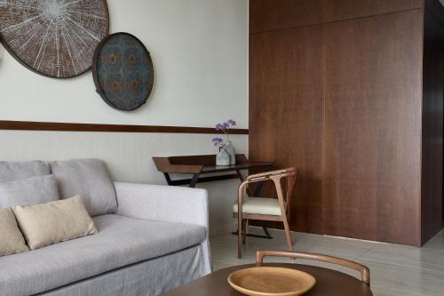 a living room with a couch and a table at Mare Paphos in Paphos