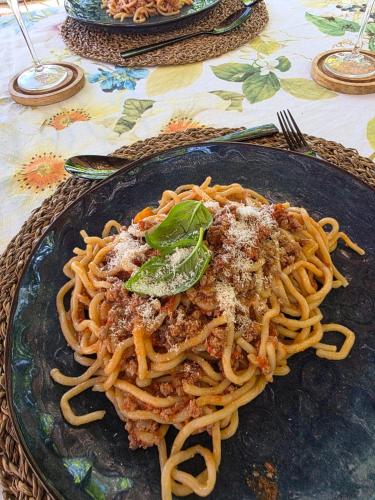 a plate of spaghetti on a table at Flat Ghino di Tacco historical centre Radicofani in Radicofani