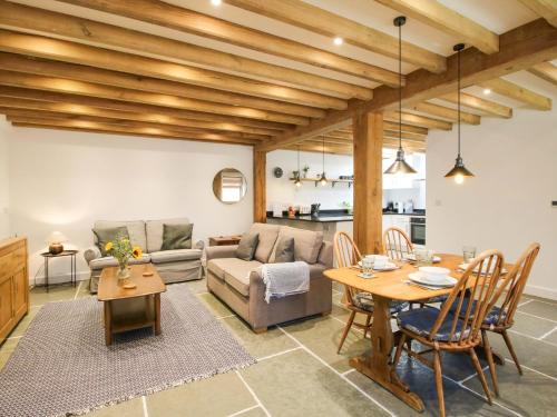 a living room with a couch and a table at The Hideaway in Bishops Castle