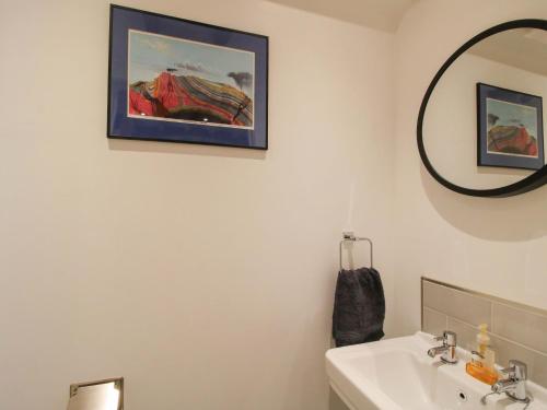 a bathroom with a sink and a mirror at The Hideaway in Bishops Castle