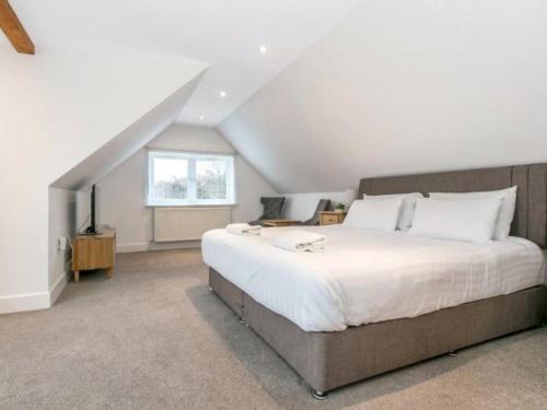 a bedroom with a large bed and a window at Sea Breeze in Poole