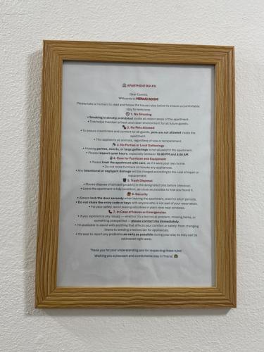 a picture of a menu in a frame on a wall at Meraki Room Tirana Center in Tirana