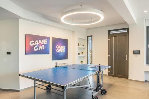 a ping pong table in the middle of a room at Māat Villa in Heraklio Town
