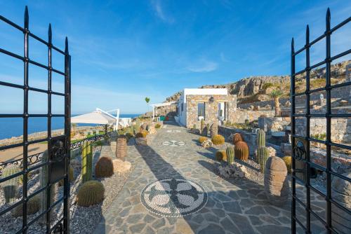 a gate with cacti in front of a building at Lindos Vigli Private Villa in Lindos